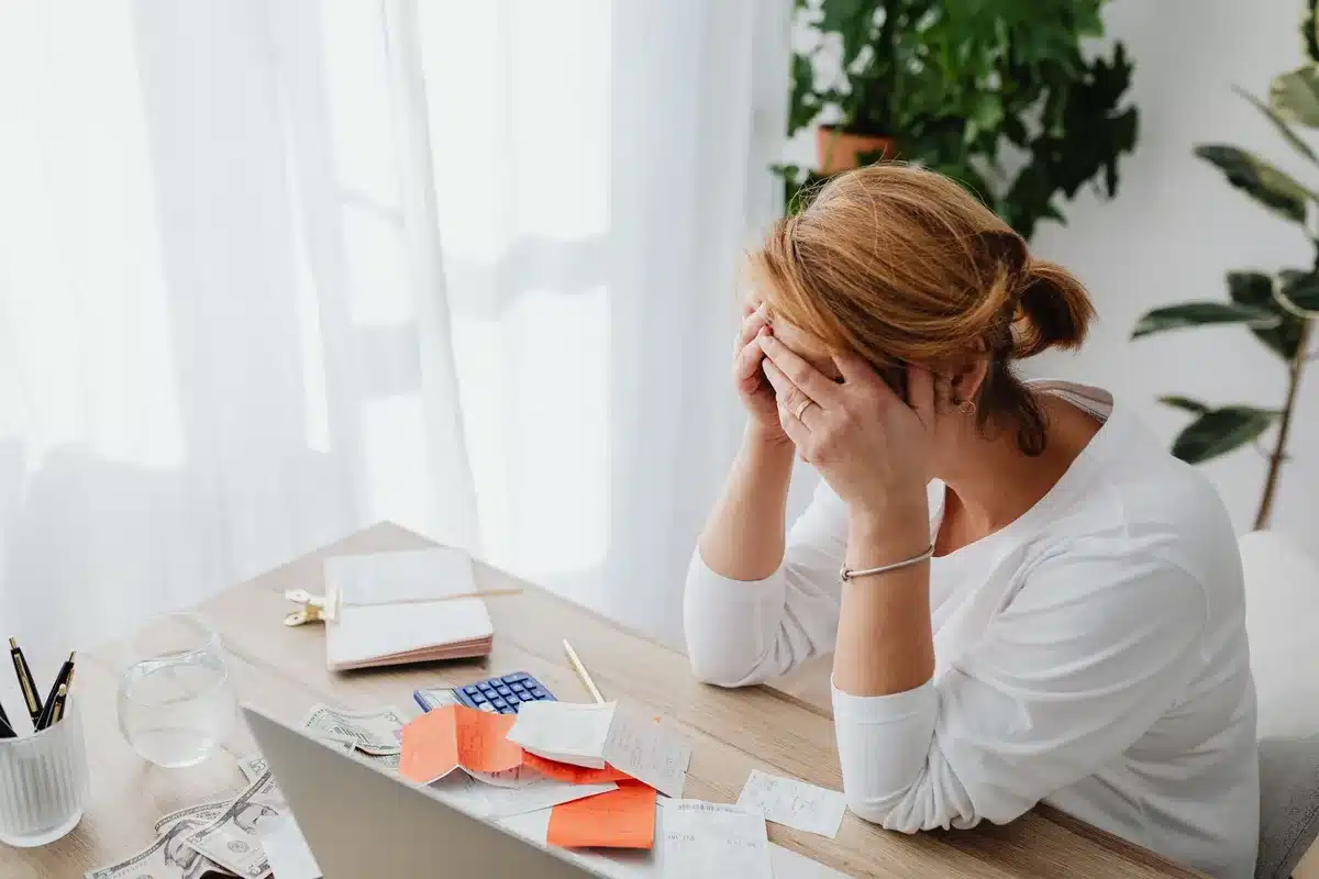 Adult reviewing bills and financial documents at a desk