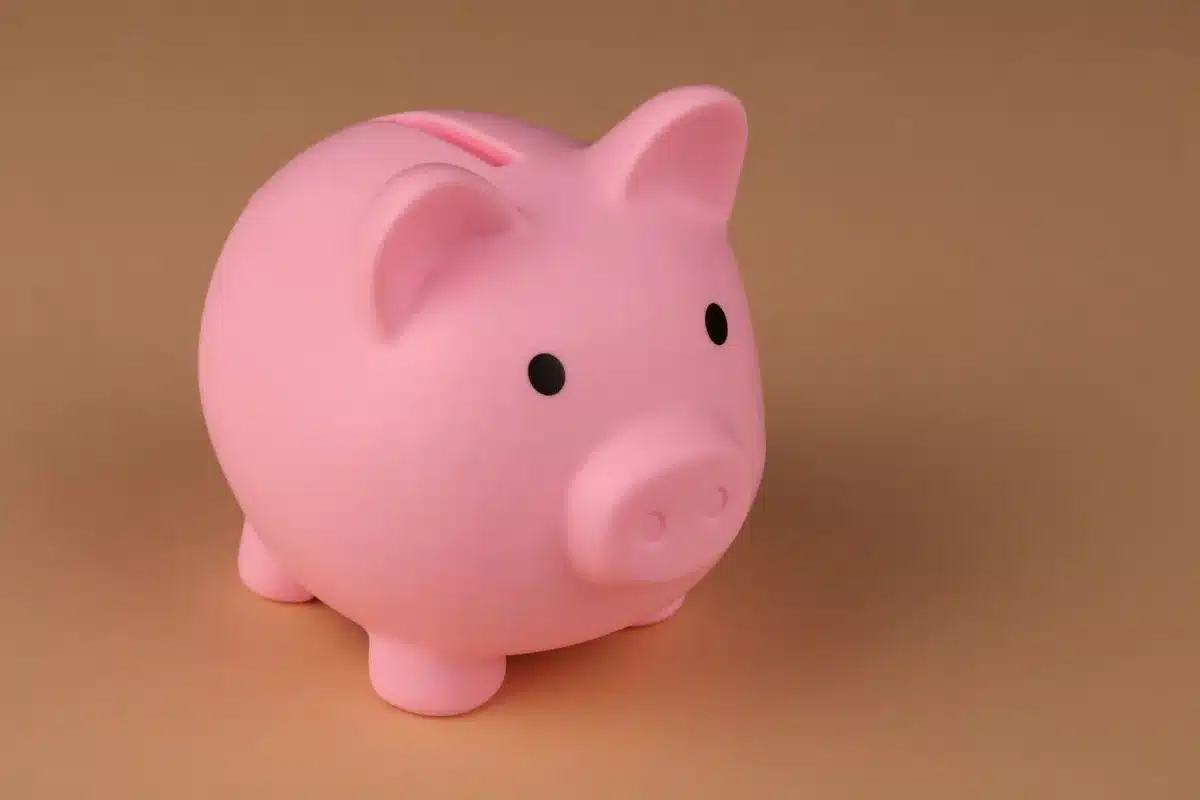Child earning allowance through age-appropriate tasks and saving in piggy bank