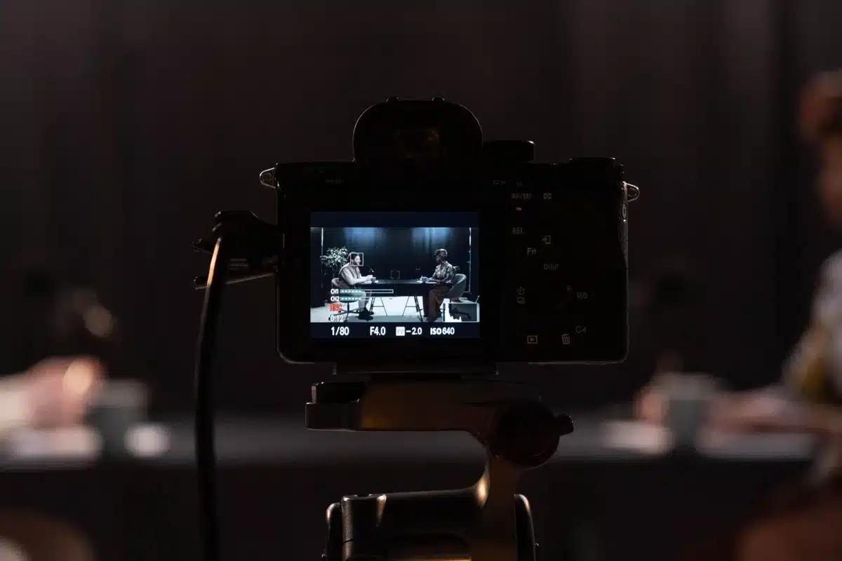 Behind-the-scenes setup of a YouTube show production with casual dining setting and camera equipment