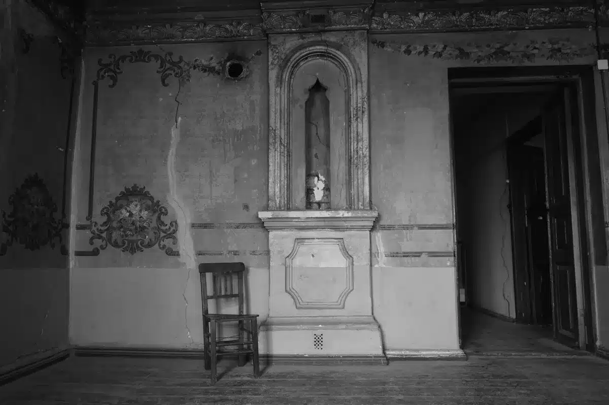 Empty royal throne in an ornate palace room with golden lighting and marble floors