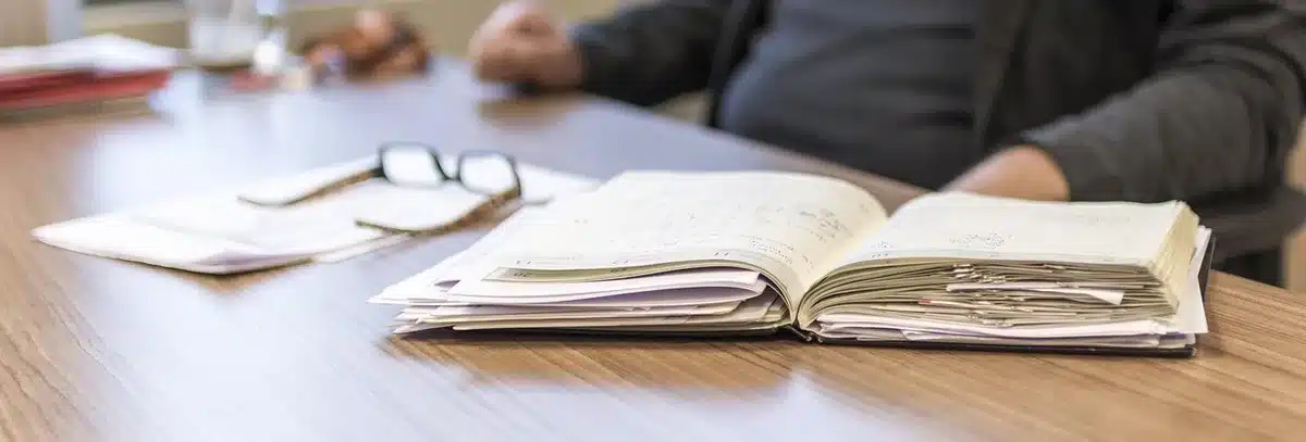 Person at desk reviewing documents during a corporate crisis management situation