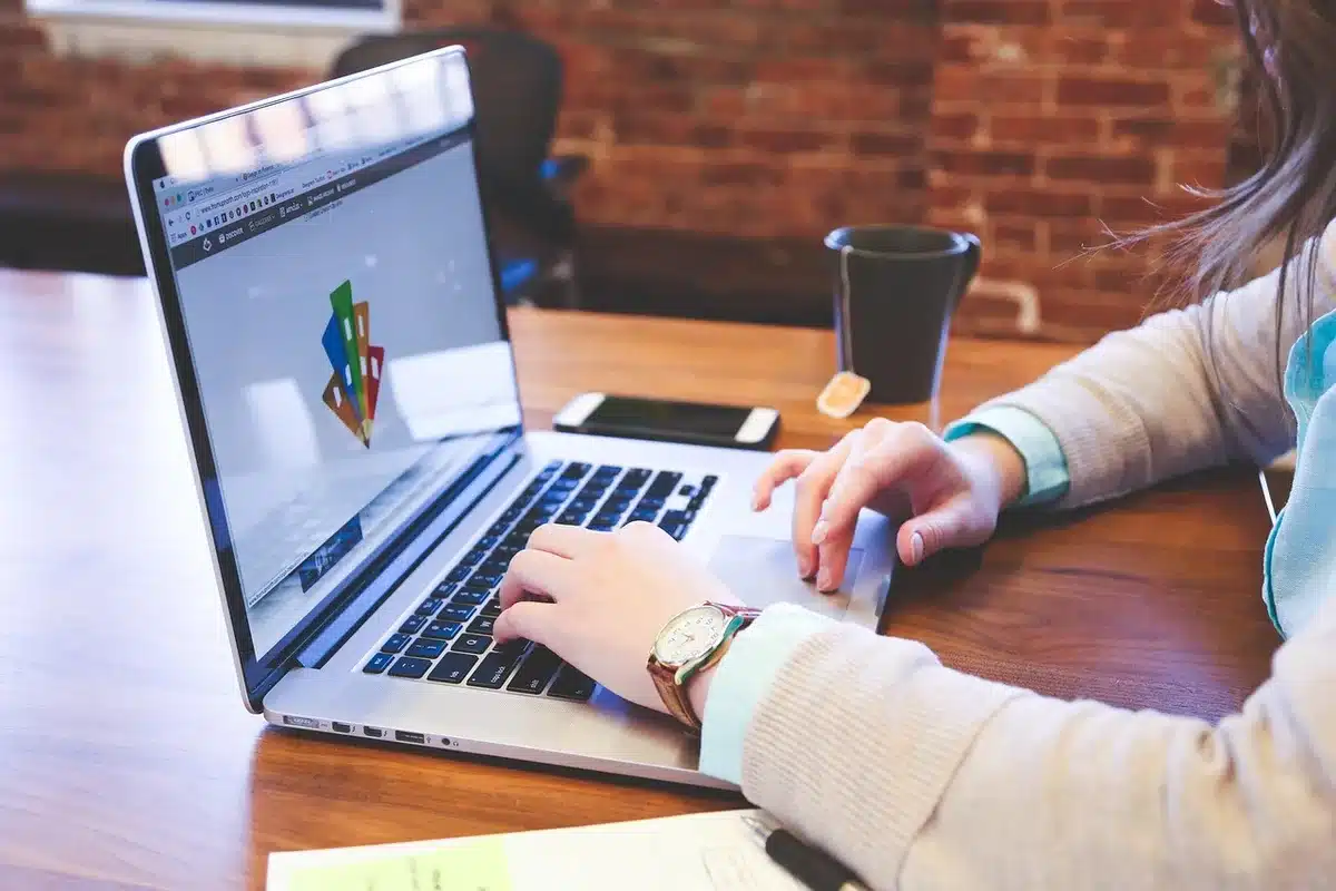 Person taking an online course on a laptop to improve professional skills