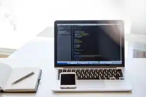 Laptop and documents on an office desk representing AI-generated content concerns