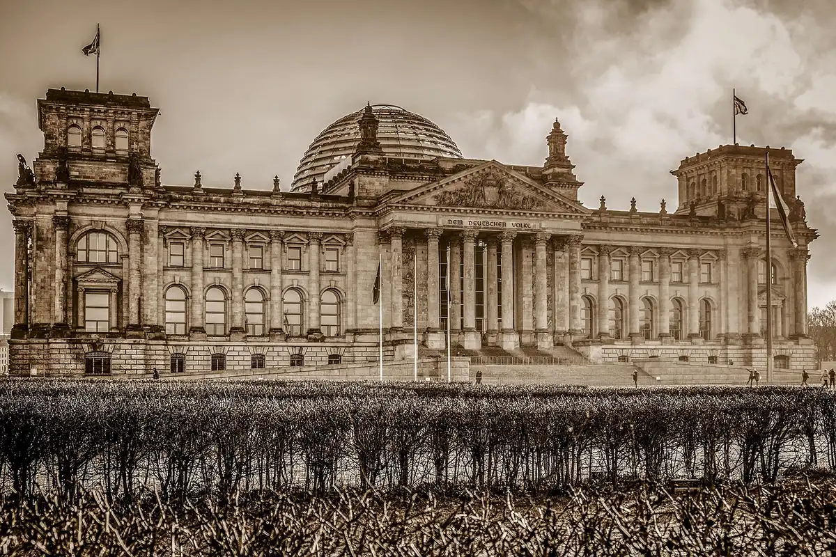 People gathered outside a government building holding signs about immigration policy