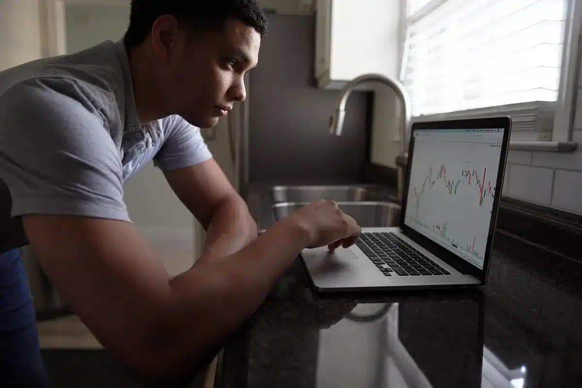 Trader reviewing investment charts on a computer screen