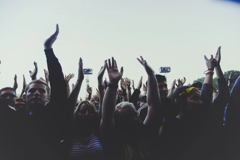 Festival audience silhouettes applauding in a grand auditorium