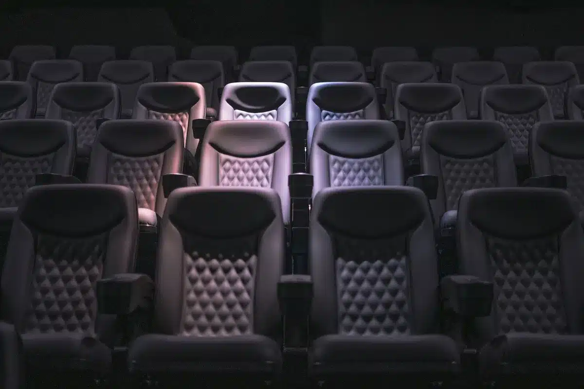 Audience at a Southeast Asian film screening with a panel discussion setup