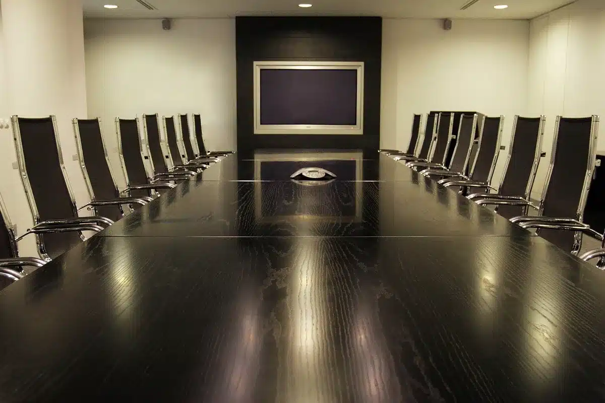 Corporate executive in modern boardroom setting with power dynamics