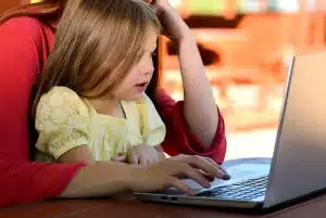 Parent and child discussing money and financial planning at a table