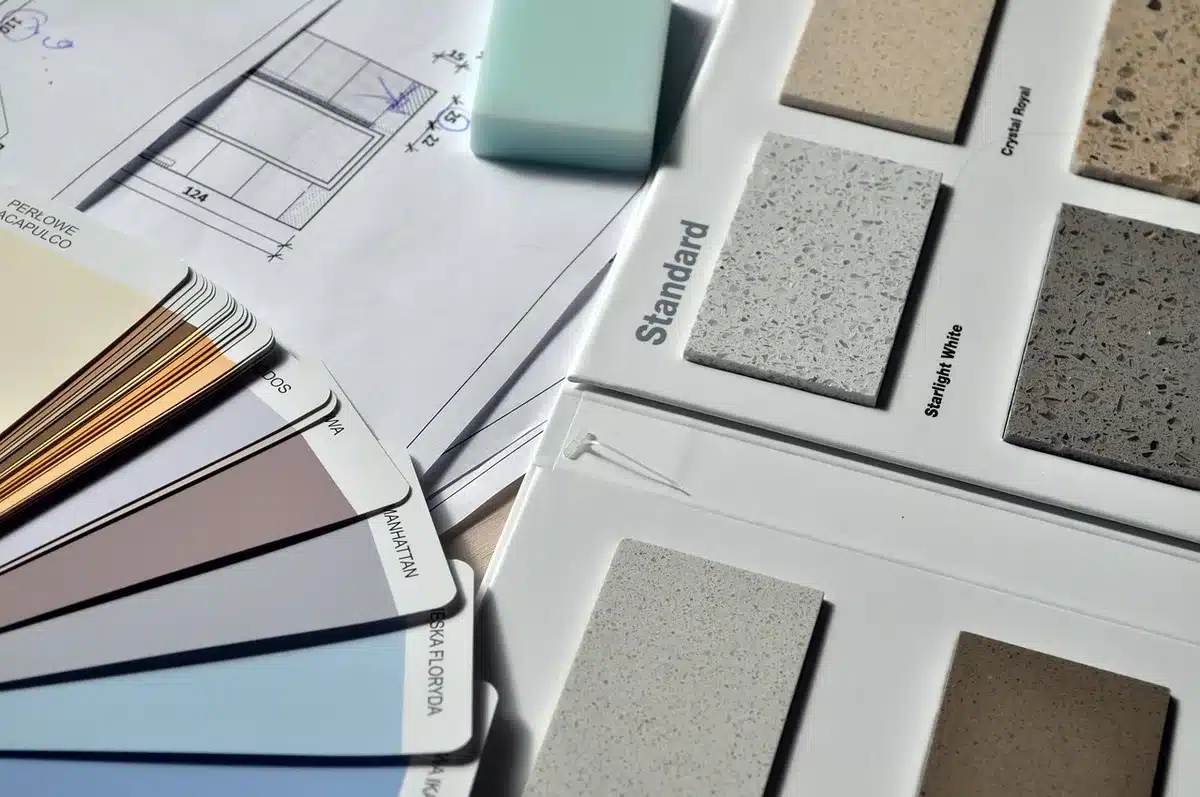 Material samples and paint swatches laid out on a kitchen island