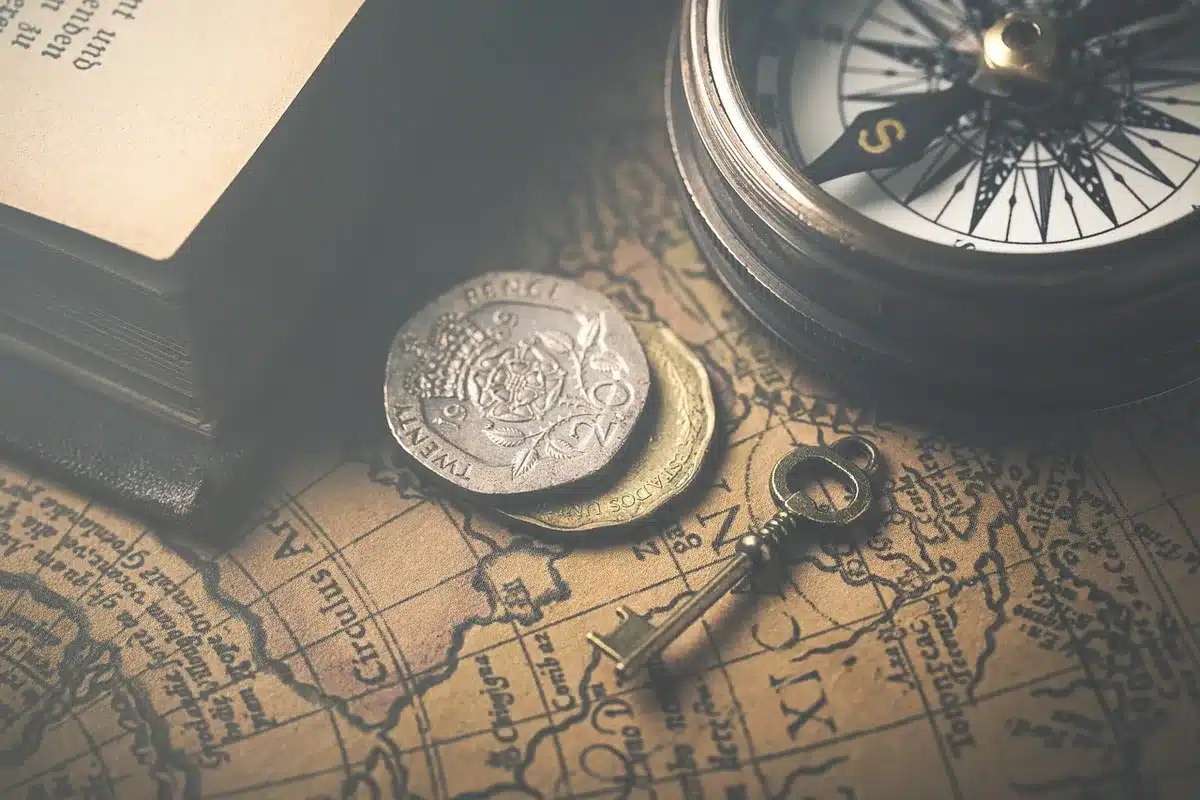 Silhouetted person with book, clock and maps on a sunlit table