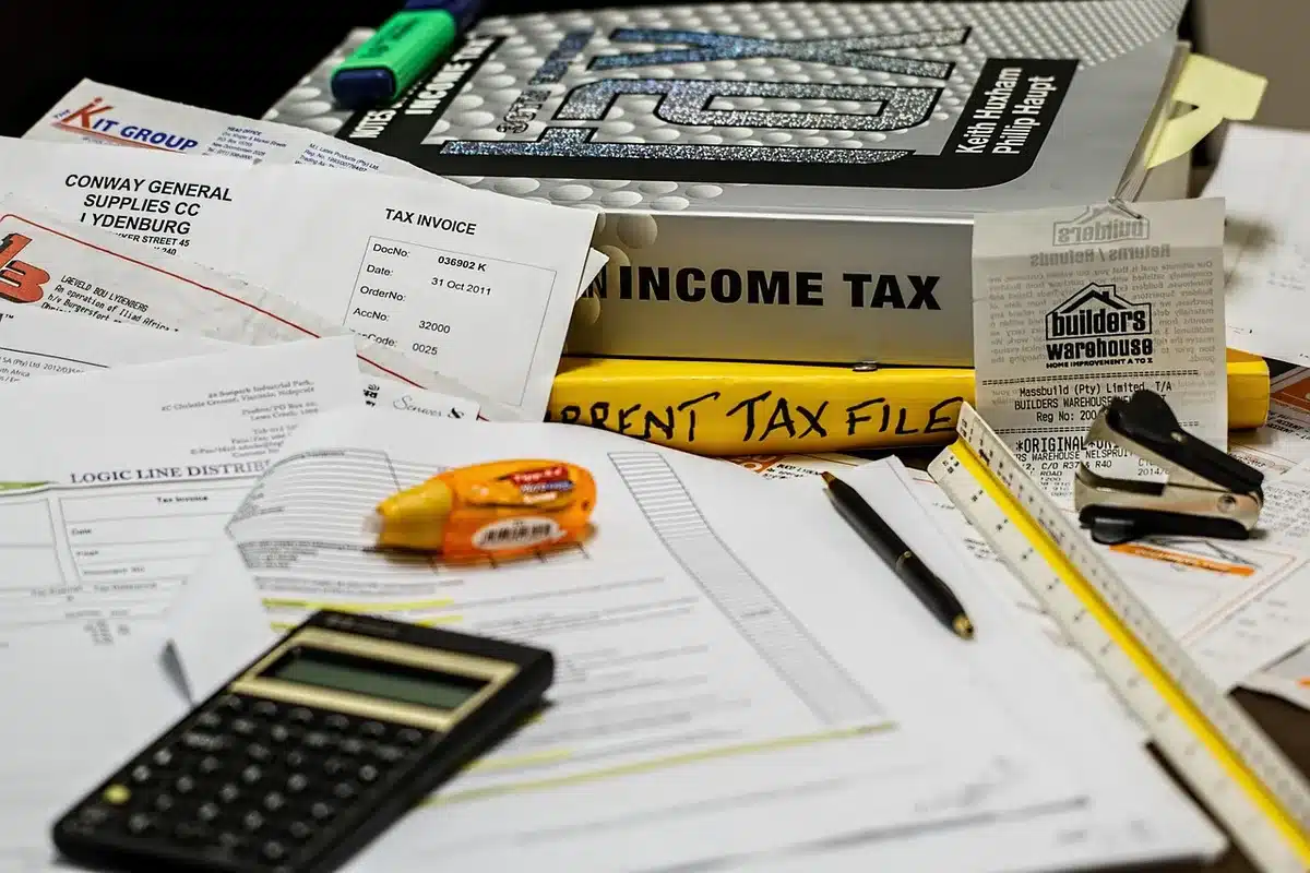 Person reviewing mortgage paperwork and calculator on a kitchen table