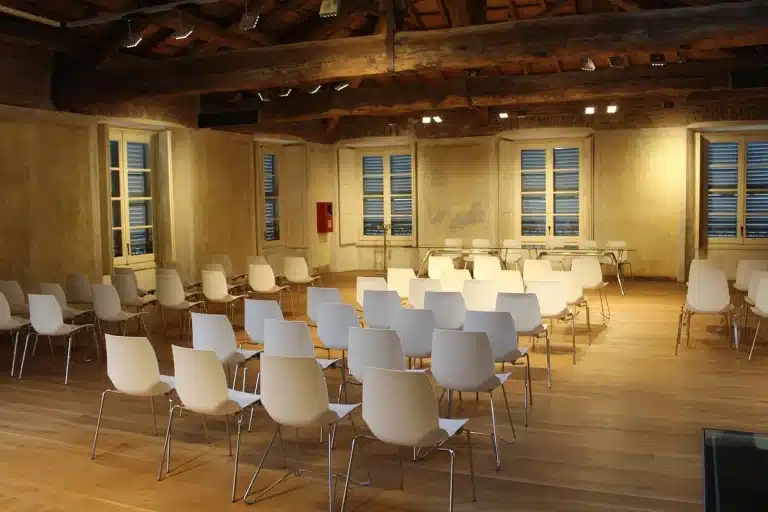 Anonymous hands and film scripts on a meeting table in a conference room