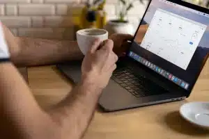 Anonymous hands sorting financial reports and charts on a conference table