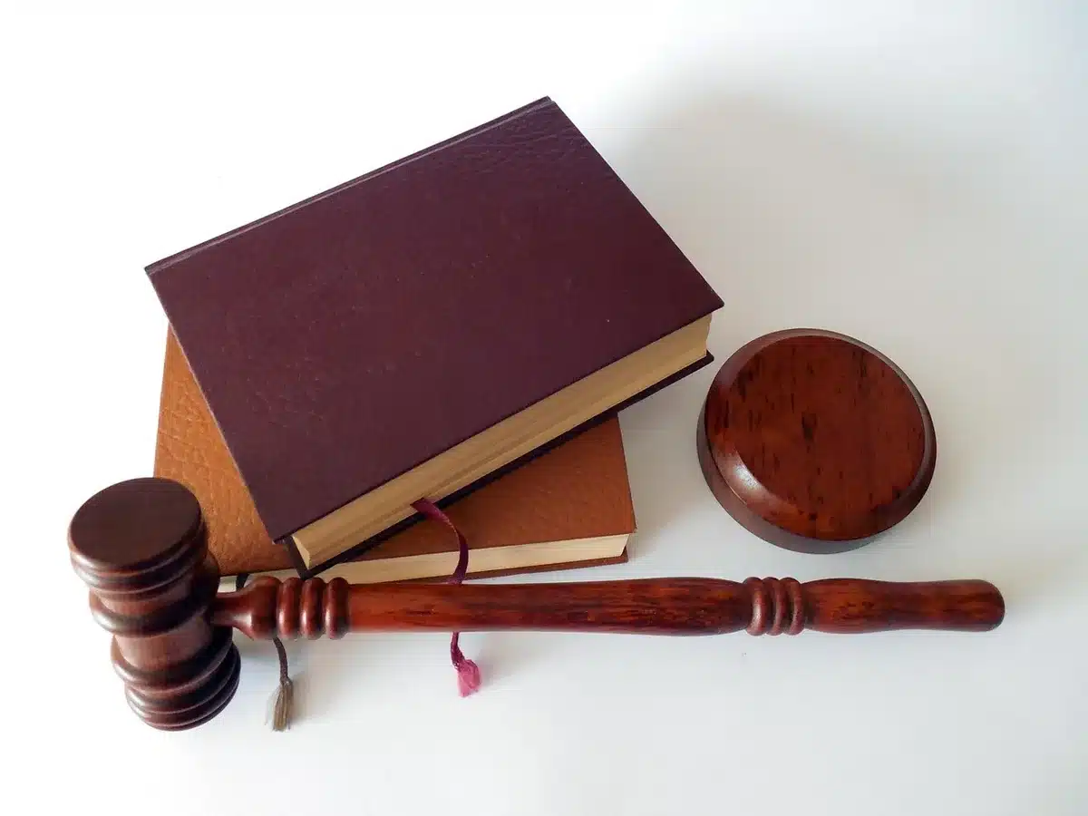 Independent lawyer studying AI on a laptop with reference books
