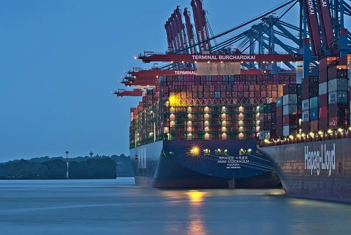 Shipping containers at a busy port representing tariffs and trade costs